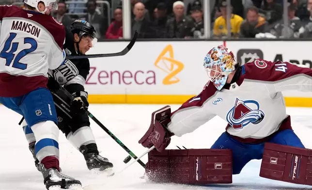 Los Angeles Kings left wing Trevor Moore, center, scores on goaltender Scott Wedgewood, right, as defenseman Josh Manson defends during the second period of Game 3 in the first round of the NHL hockey Stanley Cup playoffs Thursday, April 23, 2026, in Los Angeles. (AP Photo/Mark J. Terrill)
