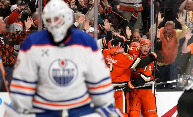 Anaheim Ducks left wing Jeffrey Viel, second from right, celebrates his goal with teammates as Edmonton Oilers goaltender Connor Ingram, left, stands in goal during the third period of Game 3 in the first round of the NHL hockey Stanley Cup playoffs series Friday, April 24, 2026, in Anaheim, Calif. (AP Photo/Mark J. Terrill)