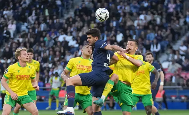 PSG's Lucas Beraldo heads the ball during the French League One soccer match between Paris Saint-Germain and Nantes in Paris, France, Wednesday, April 22, 2026. (AP Photo/Michel Euler)