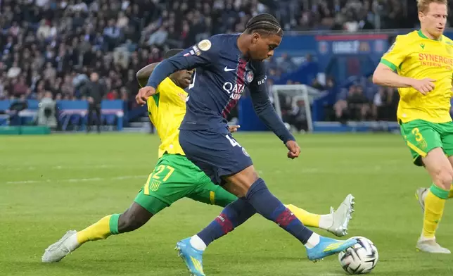 PSG's Ibrahim Mbaye, center, and Nantes' Deiver Machado challenge for the ball during the French League One soccer match between Paris Saint-Germain and Nantes in Paris, France, Wednesday, April 22, 2026. (AP Photo/Michel Euler)