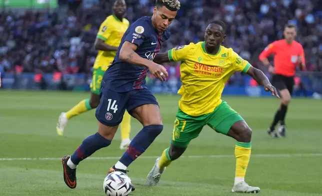 PSG's Desire Doue controls the ball past Nantes' Mohamed Kaba during the French League One soccer match between Paris Saint-Germain and Nantes in Paris, France, Wednesday, April 22, 2026. (AP Photo/Michel Euler)