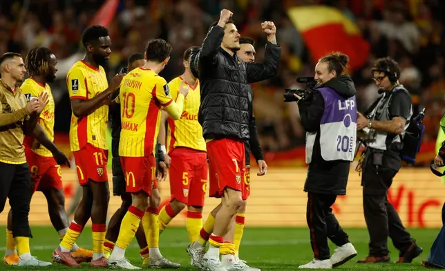 Lens players celebrate after a League One soccer match between Lens and Toulouse in Lens, France, Friday, April 17, 2026. (AP Photo/Jean-Francois Badias)
