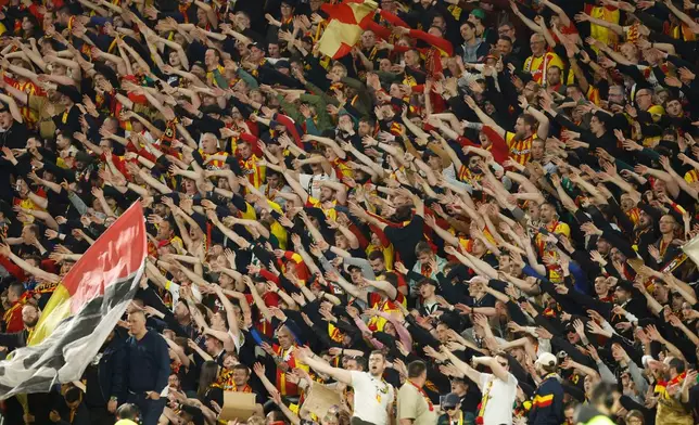 Lens fans celebrate after a League One soccer match between Lens and Toulouse in Lens, France, Friday, April 17, 2026. (AP Photo/Jean-Francois Badias)