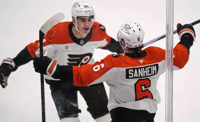 Philadelphia Flyers' Travis Sanheim (6) celebrates with Porter Martone (94) after scoring during the third period of Game 1 in the first round of the NHL Stanley Cup playoffs against the Pittsburgh Penguins in Pittsburgh, Saturday, April 18, 2026. (AP Photo/Gene J. Puskar)