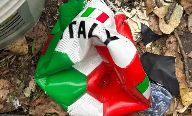 A broken soccer ball is pictured on a street in Rome, Wednesday, April 1, 2026. (AP Photo/Gregorio Borgia)