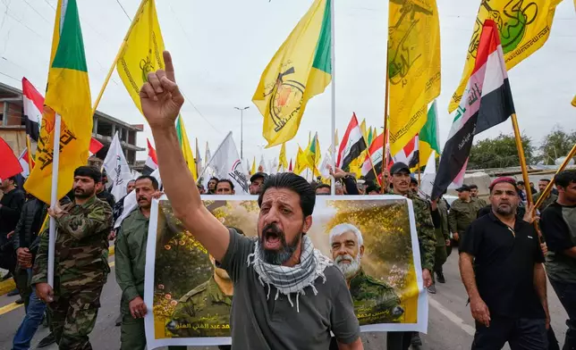 Members from the Popular Mobilization Forces attend a funeral of fighters who were killed in a U.S. airstrike, in Tal Afar, Nineveh province, north of Baghdad, Iraq, Thursday, April 2, 2026. (AP Photo/Hadi Mizban)