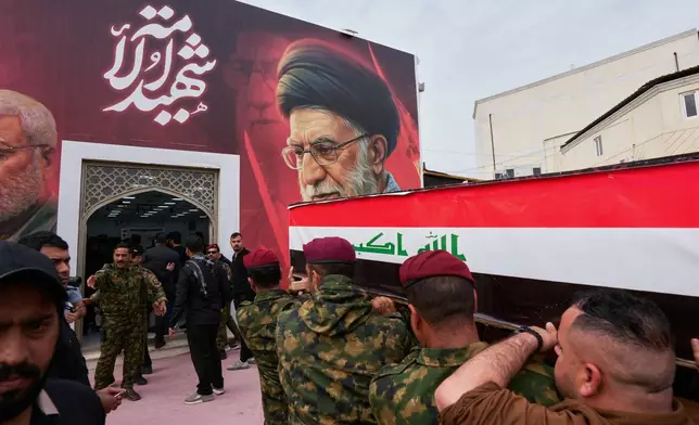 Members from the Popular Mobilization Forces attend a funeral of fighters who were killed in a U.S. airstrike, in Tal Afar, Nineveh province, north of Baghdad, Iraq, Thursday, April 2, 2026. (AP Photo/Hadi Mizban)