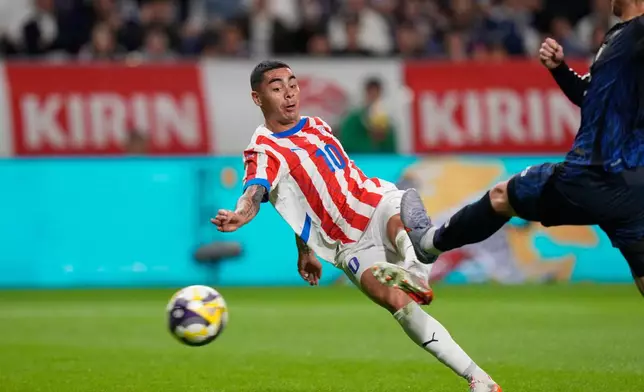 FILE - Paraguay's Miguel Almiron shoots to score as Japan's Koki Ogawa attempts to block during the friendly soccer match between Japan and Paraguay on Friday, Oct. 10, 2025, in Suita, Osaka, western Japan. (AP Photo/Eugene Hoshiko, File)