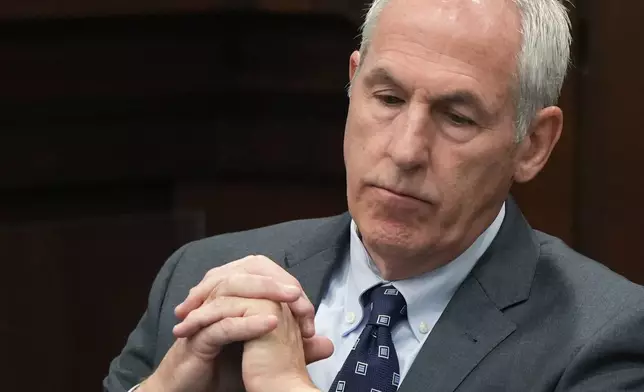 Defendant ex-FirstEnergy Senior Vice President Michael Dowling watches a live transcription of an in chamber conference on a jury question in Summit County Common Pleas Judge Susan Baker Ross' courtroom in Akron, Ohio, on Tuesday, March 31, 2026. (Mike Cardew /Akron Beacon Journal via AP, Pool)