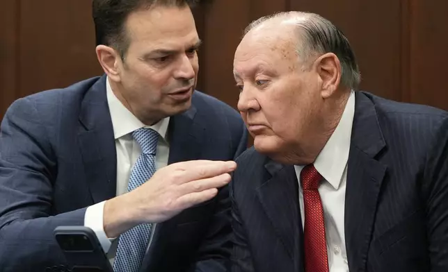 Defense attorney George Stamboulidis talks with defendant former FirstEnergy CEO Chuck Jones after a jury question in Summit County Common Pleas Judge Susan Baker Ross' courtroom in Akron, Ohio, on Tuesday, March 31, 2026. (Mike Cardew /Akron Beacon Journal via AP, Pool)