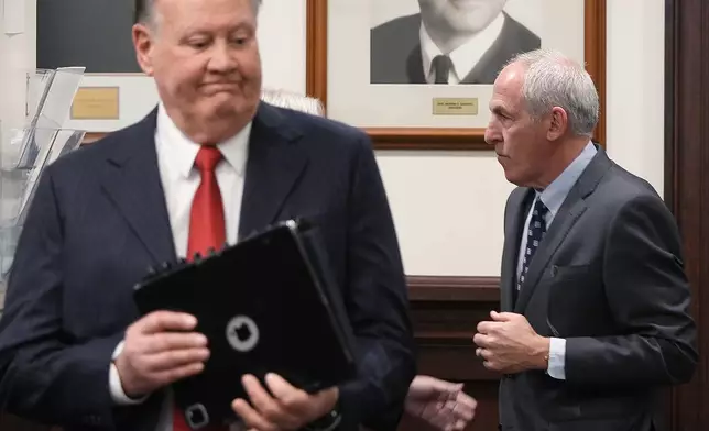 Defendants former FirstEnergy CEO Chuck Jones and ex-FirstEnergy Senior Vice President Michael Dowling enter the courtroom in Summit County Common Pleas Judge Susan Baker Ross' courtroom in Akron, Ohio, on Tuesday, March 31, 2026. (Mike Cardew /Akron Beacon Journal via AP, Pool)
