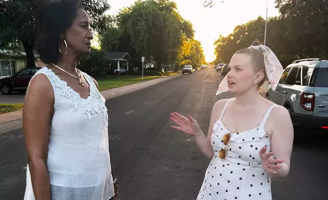 Sandra Kennedy, left, and Casey Clowes, candidates for the Salt River Project governor board, speak while canvassing in Tempe, Ariz., on Wednesday, April 1, 2026. (AP Photo/Jonathan J. Cooper)