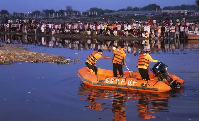 State Disaster Response Force (SDRF) personnel search the site where a boat carrying pilgrims capsized in the Yamuna river in Vrindavan, India, Friday, April 10, 2026. (AP Photo)