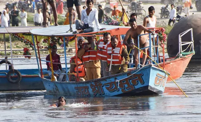 Rescuers search the site where a boat carrying pilgrims capsized in the Yamuna river in Vrindavan, India, Friday, April 10, 2026. (AP Photo)