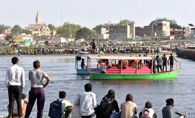 Rescuers search the site where a boat carrying pilgrims capsized in the Yamuna river in Vrindavan, India, Friday, April 10, 2026. (AP Photo)