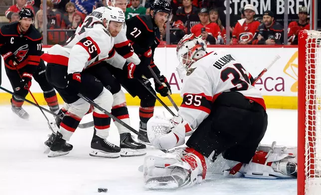 Ottawa Senators goaltender Linus Ullmark (35) has the shot of Carolina Hurricanes' Nikolaj Ehlers (27) go wide of the net with Senators' Jake Sanderson (85) nearby during the second period of Game 2 of an NHL hockey Stanley Cup first-round playoff series in Raleigh, N.C., Monday, April 20, 2026. (AP Photo/Karl DeBlaker)