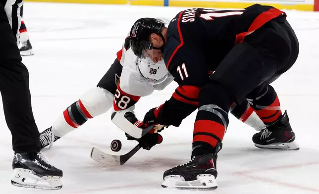 Carolina Hurricanes' Jordan Staal (11) wins a face-off against Ottawa Senators' Claude Giroux (28) during the first period of Game 2 of an NHL hockey Stanley Cup first-round playoff series in Raleigh, N.C., Monday, April 20, 2026. (AP Photo/Karl DeBlaker)