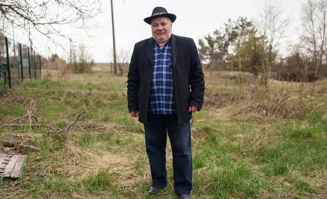 Oleksii Harbyz, 72, part of a unit sent to clean up contamination from the 1986 Chernobyl nuclear plant accident, poses for a portrait near the facility in Chernobyl, Ukraine, Tuesday, April 21, 2026. (AP Photo/Evgeniy Maloletka)
