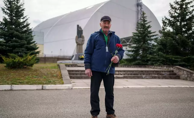 Anatolii Krutik, 63, who helped clean up contamination from the Chernobyl nuclear power plant accident, poses for a portrait Tuesday, April 21, 2026, in front of the plant in Chernobyl, Ukraine. (AP Photo/Evgeniy Maloletka)