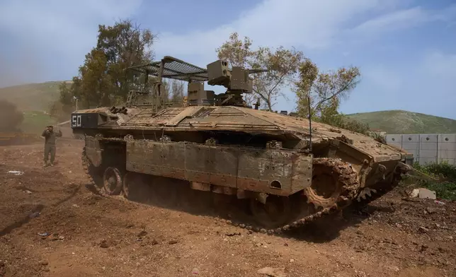 An Israeli soldier directs a military vehicle in northern Israel, on the border with Lebanon following a ceasefire between Israel and Hezbollah, Friday, April 17, 2026. (AP Photo/Ariel Schalit)
