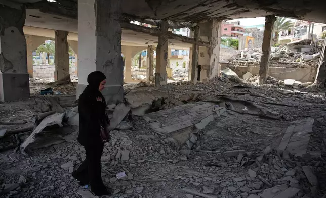 A local resident walks among debris inside a mosque destroyed in an Israeli airstrike in Jibchit, southern Lebanon, Friday, April 17, 2026, following a ceasefire between Israel and Hezbollah. (AP Photo/Hassan Ammar)