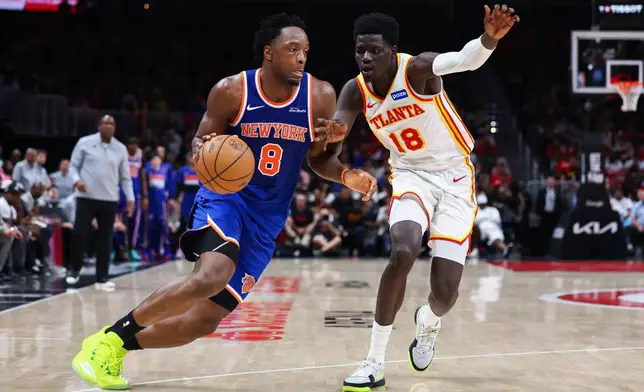 New York Knicks forward Og Anunoby (8) drives to the basket against Atlanta Hawks forward Mouhamed Gueye (18) during the second half in Game 3 of a first-round NBA playoffs basketball series, Thursday, April 23, 2026, in Atlanta. (AP Photo/Colin Hubbard)