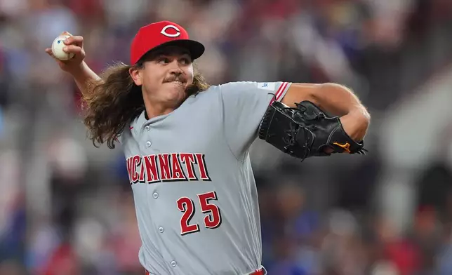 Cincinnati Reds starting pitcher Rhett Lowder throws during the first inning of a baseball game against the Texas Rangers, Saturday, April 4, 2026, in Arlington, Texas. (AP Photo/LM Otero)