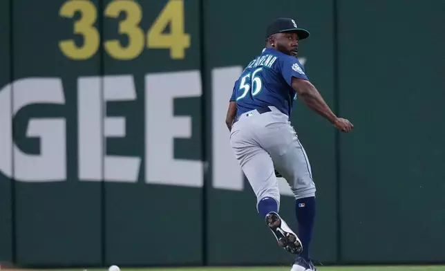 Seattle Mariners outfielder Randy Arozarena (56) chases a double by Texas Rangers designated hitter Joc Pederson, not visible, during the fourth inning of a baseball game Monday, April 6, 2026, in Arlington, Texas. (AP Photo/Julio Cortez)