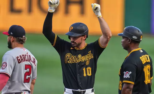 Pittsburgh Pirates' Bryan Reynolds (10) celebrates as he stands on first base after driving in a run with a single off Washington Nationals pitcher Cade Cavalli (not shown) during the second inning of a baseball game in Pittsburgh, Monday, April 13, 2026. (AP Photo/Gene J. Puskar)