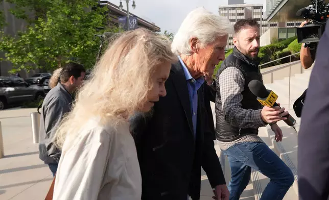Suzanne Morrison, mother of Matthew Perry, walks into court with her husband Keith Morrison before Jasveen Sangha, who plead guilty to selling Perry a lethal dose of the drug ketamine in the days before his death, appears in court for sentencing on Wednesday, April 8, 2026 in Los Angeles. (AP Photo/Damian Dovarganes)