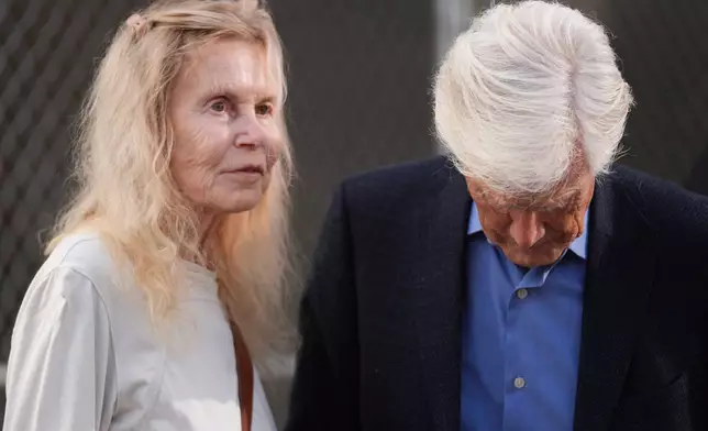 Suzanne Morrison, mother of Matthew Perry, walks into court with her husband Keith Morrison before Jasveen Sangha, who plead guilty to selling Perry a lethal dose of the drug ketamine in the days before his death, appears in court for sentencing on Wednesday, April 8, 2026 in Los Angeles. (AP Photo/Damian Dovarganes)