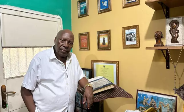 Bwatshia Kambayi, a Congolese scholar and former higher education minister who has written about Kimbanguism, poses at his home in Kinshasa, Democratic Republic of the Congo, Sunday, April 5, 2026. (AP Photo/Rodney Muhumuza)