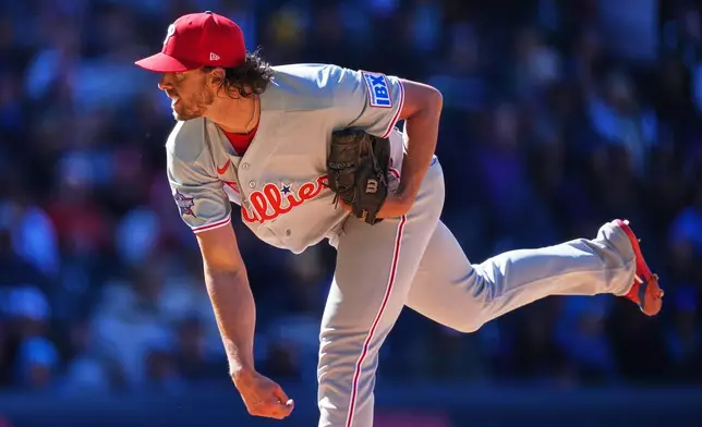 Philadelphia Phillies starting pitcher Aaron Nola works against the Colorado Rockies in the fifth inning of a baseball game Friday, April 3, 2026, in Denver. (AP Photo/David Zalubowski)
