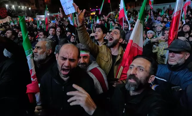 Iranian pro-government demonstrators attend a gathering after announcement of a two-week ceasefire in the war with the United States and Israel, at the Enqelab-e-Eslami, or Islamic Revolution, Square, in Tehran, Iran, Wednesday, April 8, 2026. (AP Photo/Vahid Salemi)