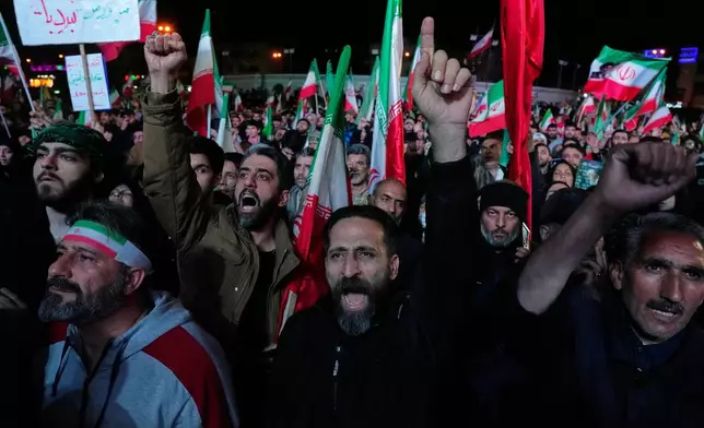 Iranian pro-government demonstrators chant slogans in a gathering after announcement of a two-week ceasefire in the war with the United States and Israel, at the Enqelab-e-Eslami, or Islamic Revolution, Square, in Tehran, Iran, Wednesday, April 8, 2026. (AP Photo/Vahid Salemi)