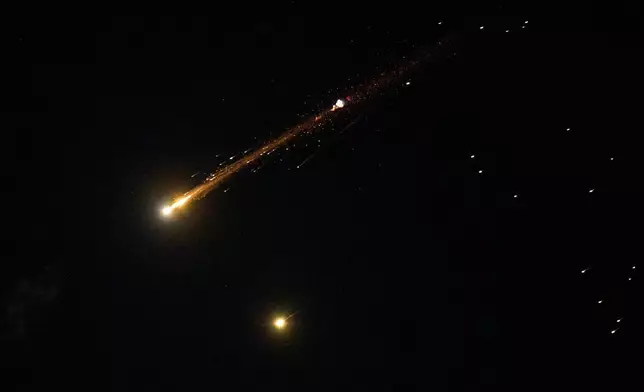 An Iranian cluster munition missile explodes in the sky over northern Israel, Wednesday, April 8, 2026. (AP Photo/Ariel Schalit)