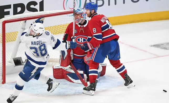Montreal Canadiens goaltender Jakub Dobes (75) and defenceman Mike Matheson (8) look back on their goal after being scored Tampa Bay Lightning's Brandon Hagel (38) during third period of an NHL playoff hockey action in Montreal, Sunday, April 26, 2026. (Graham Hughes/The Canadian Press, via AP)