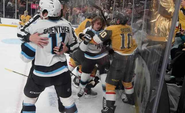 Vegas Golden Knights and Utah Mammoth players fight during the first period of Game 5 of a first-round NHL hockey Stanley Cup playoff series Wednesday, April 29, 2026, in Las Vegas. (AP Photo/John Locher)