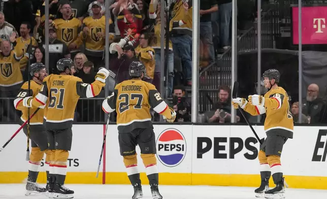 Vegas Golden Knights right wing Pavel Dorofeyev, right, celebrates after scoring against the Utah Mammoth during the first period of Game 5 of a first-round NHL hockey Stanley Cup playoff series Wednesday, April 29, 2026, in Las Vegas. (AP Photo/John Locher)