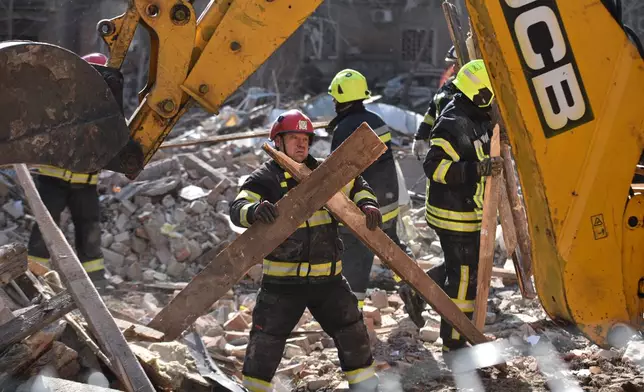 A rescue worker clears the rubble after a Russian strike on residential neighbourhood of Dnipro, Ukraine, Saturday, April 25, 2026. (AP Photo/Mykola Synelnykov)