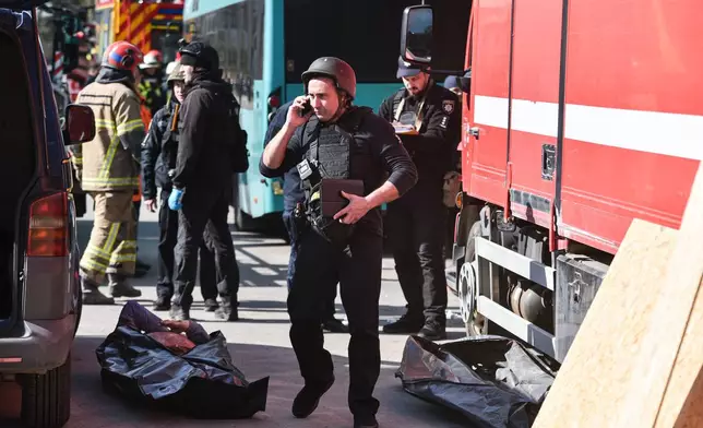 Police inspect a body recovered from the rumble of a residential building destroyed by a Russian strike, in Dnipro, Ukraine, Saturday, April 25, 2026. (AP Photo/Mykola Synelnykov)