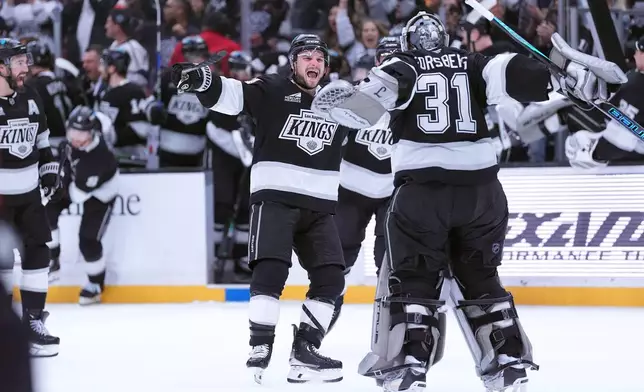 Los Angeles Kings' center Scott Laughton (21) celebrates with goaltender Anton Forsberg (31) after Kings' 3-2 shootout win over the Nashville Predators during an NHL hockey game Monday, April 6, 2026, in Los Angeles. (AP Photo/Scott Strazzante)