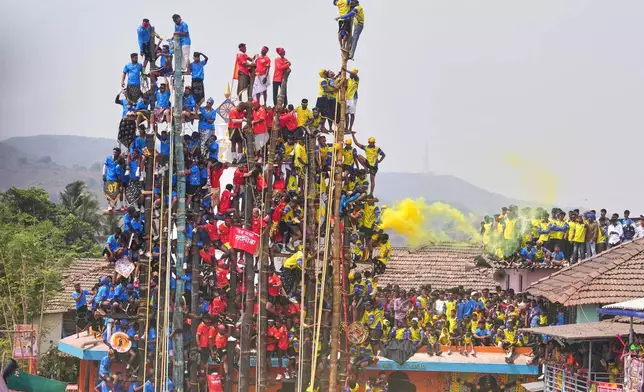 Members of the Agri-Koli community compete to erect ceremonial bamboo poles in a centuries-old annual tradition honoring the local goddess Raiba Devi, in Rave village near Mumbai, India, Friday, April 17, 2026. (AP Photo/Rafiq Maqbool)