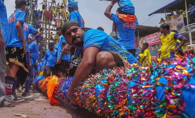 Members of the Agri-Koli community compete to erect ceremonial bamboo poles in a centuries-old annual tradition honoring the local goddess Raiba Devi, in Rave village near Mumbai, India, Friday, April 17, 2026. (AP Photo/Rafiq Maqbool)