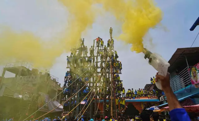 Members of the Agri-Koli community erect ceremonial bamboo poles in a centuries-old annual tradition honoring the local goddess Raiba Devi, in Rave village near Mumbai, India, Friday, April 17, 2026. (AP Photo/Rafiq Maqbool)