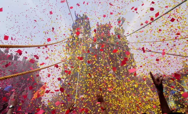 Members of the Agri-Koli community celebrate as they compete to erect ceremonial bamboo poles in a centuries-old annual tradition honoring the local goddess Raiba Devi, in Rave village, near Mumbai, India, Friday, April 17, 2026. (AP Photo/Rafiq Maqbool)