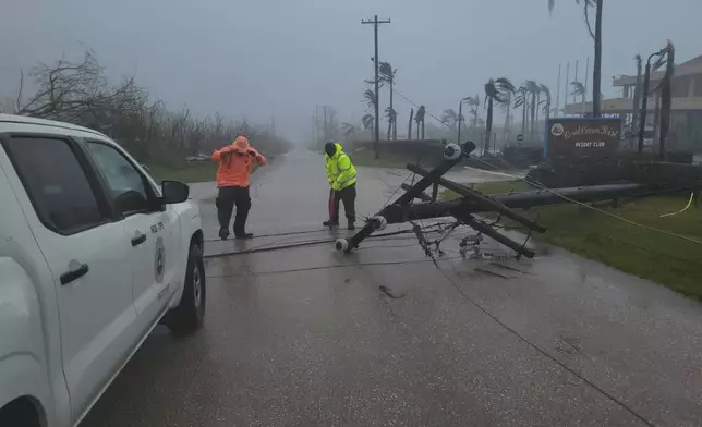 A utility pole blocks the road in Saipan on Wednesday, April 15, 2026, as a super typhoon with ferocious winds and relentless rains, shredded tin roofs and forced residents to take cover from flying tree limbs. (Office of the Mayor, municipality of Saipan via AP)
