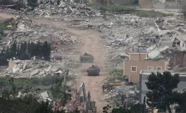 Israeli army vehicles and bulldozers operate in southern Lebanon, as seen from northern Israel, Wednesday, April 15, 2026. (AP Photo/Ariel Schalit)