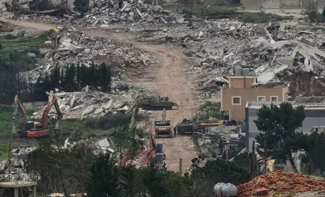 Israeli army vehicles and bulldozers operate in southern Lebanon, as seen from northern Israel, Wednesday, April 15, 2026. (AP Photo/Ariel Schalit)