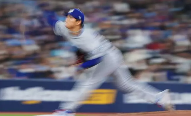 Los Angeles Dodgers pitcher Yoshinobu Yamamoto (18) works against the Toronto Blue Jays during the sixth inning of an MLB baseball game in Toronto on Tuesday, April 7, 2026. (Nathan Denette/The Canadian Press via AP)